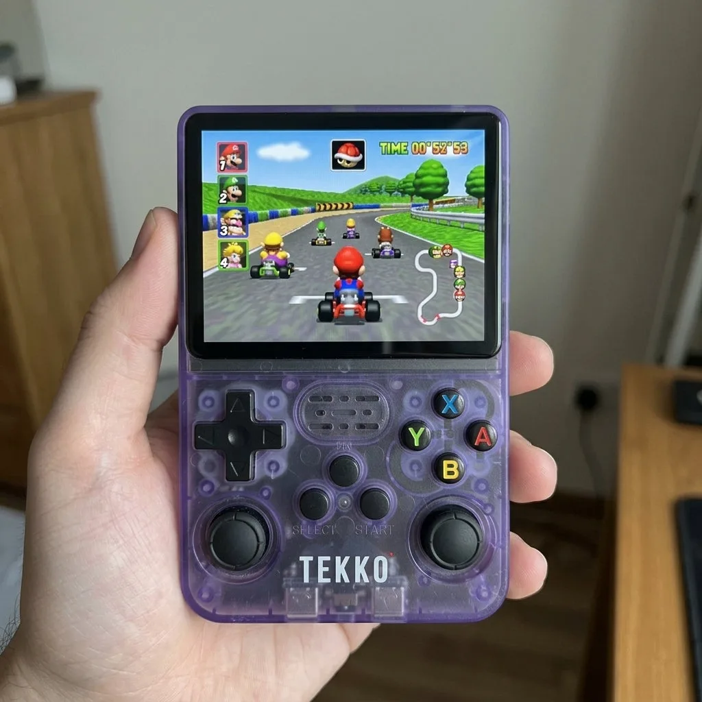The Tekko One held in hand, powered on and running Mario Kart 64