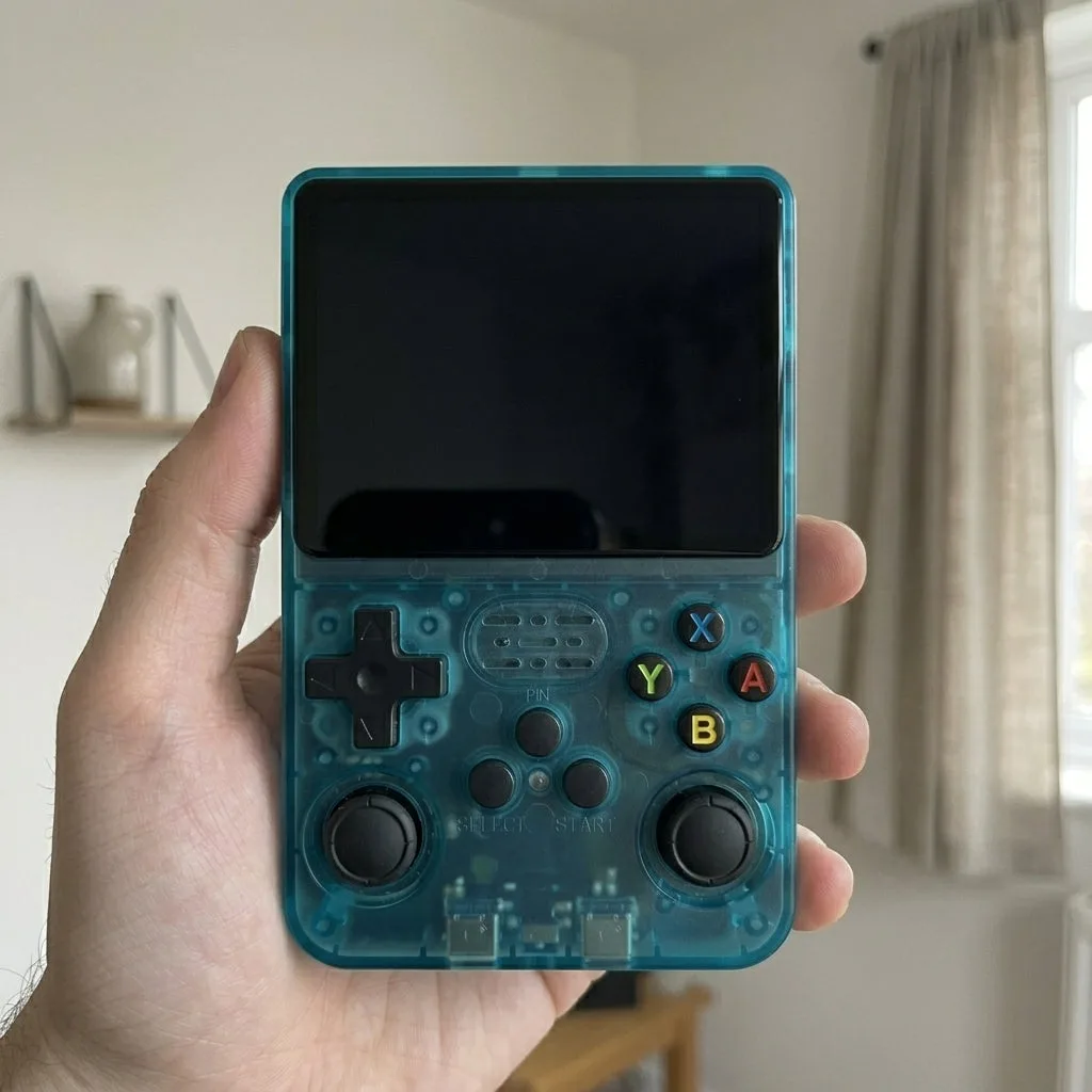 Unit 04, the teal TikTok Shop unit, held in the same hand with a dead black screen